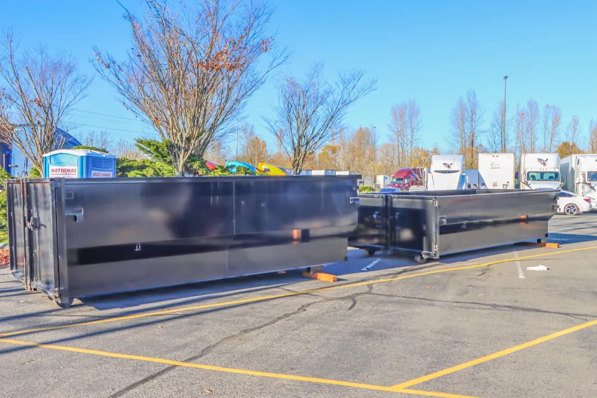 Professional dumpster rental service with roll-off container on residential driveway in Newberg